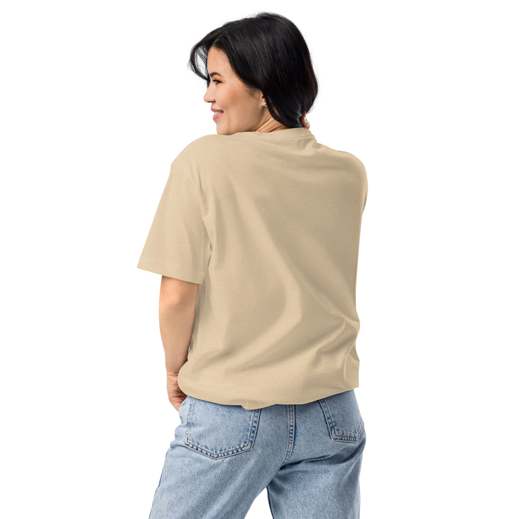 Woman wearing a beige t-shirt and blue jeans on a white background