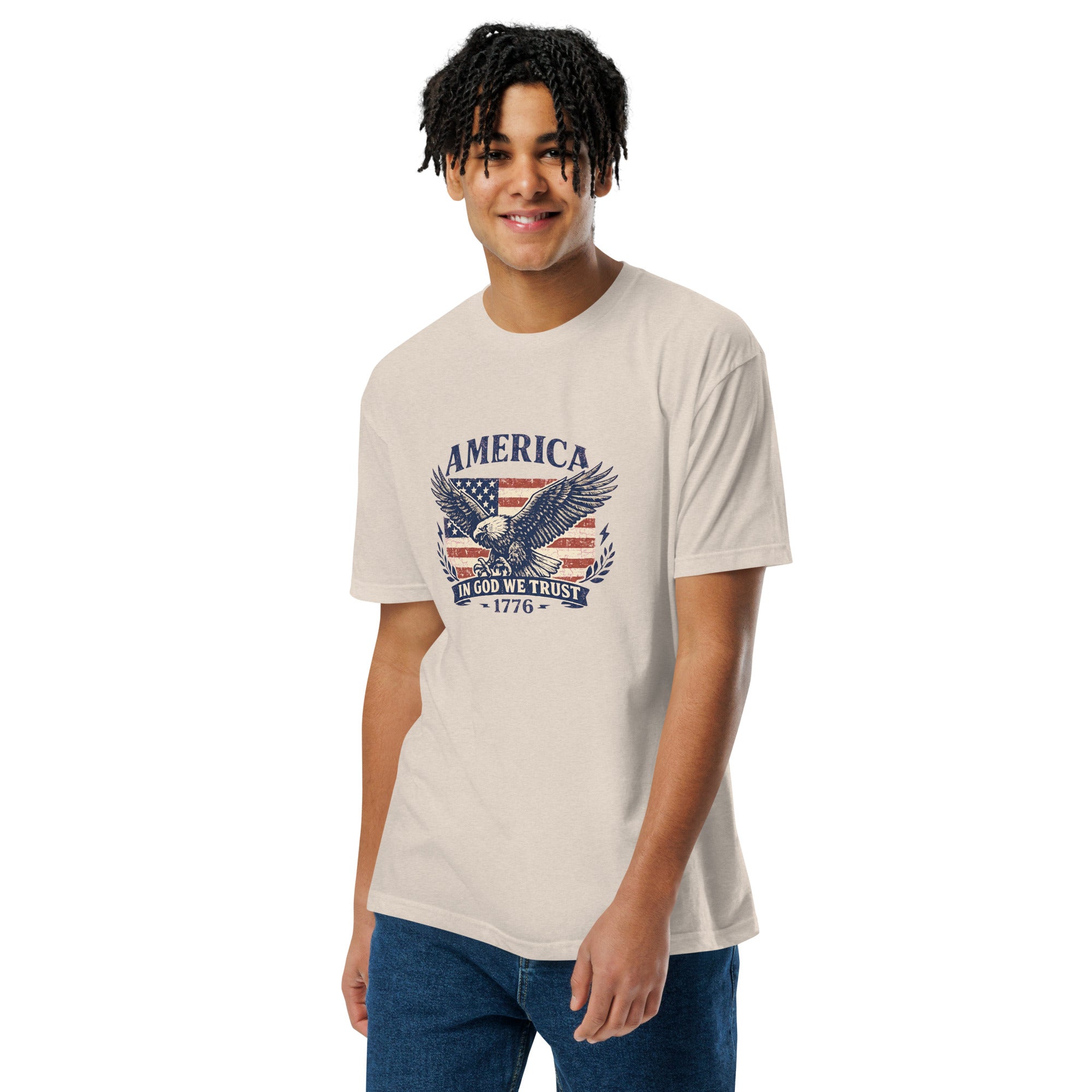 Person wearing a beige t-shirt with an eagle and flag design on a white background